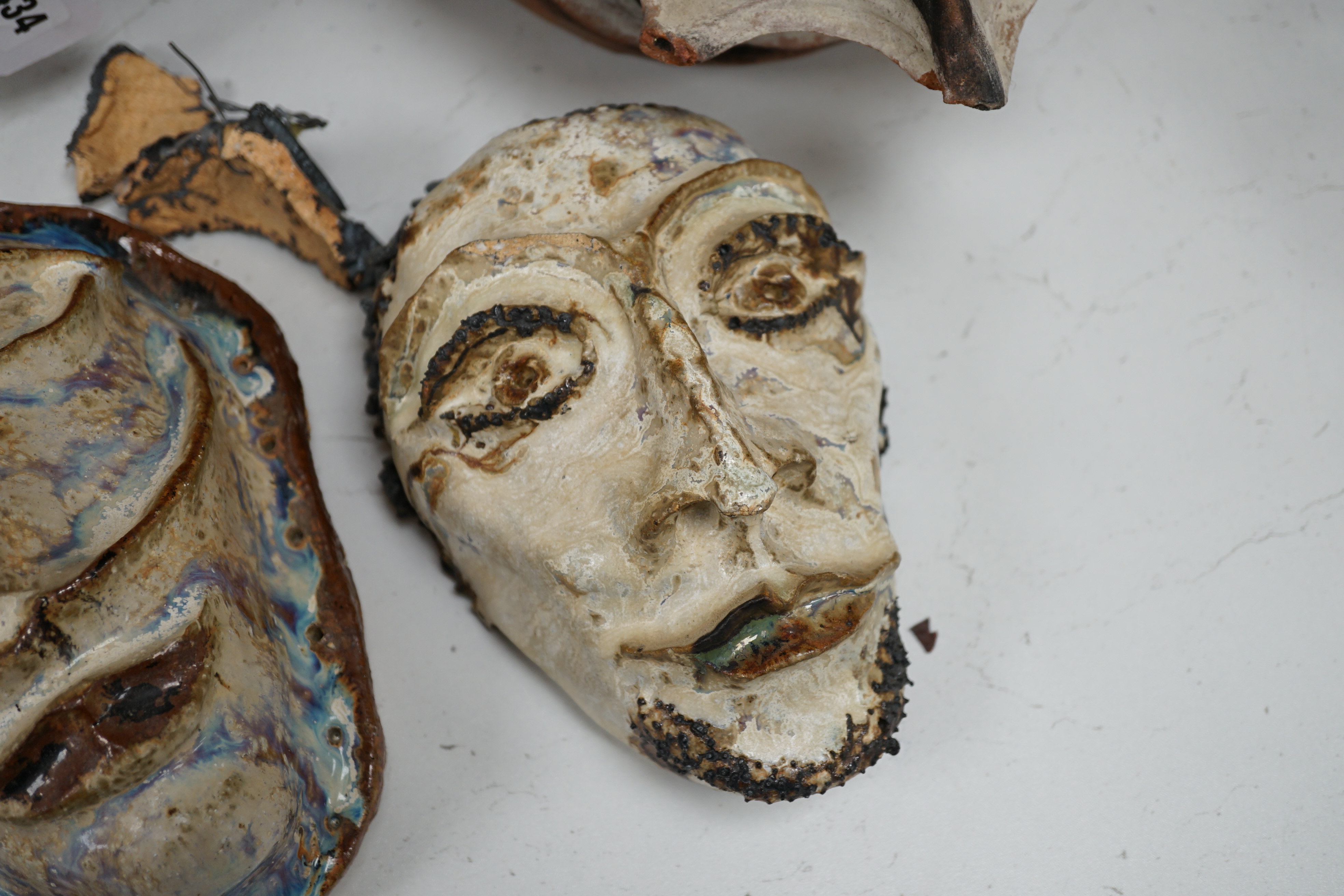 Two Papa New Guinea pottery face masks and two cooking pots